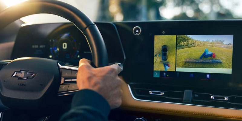 Chevrolet Equinox interior showing driver view with digital display and rear camera system.