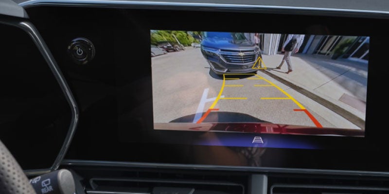 Chevrolet Equinox rearview camera display showing parking guidelines and surrounding vehicle view.