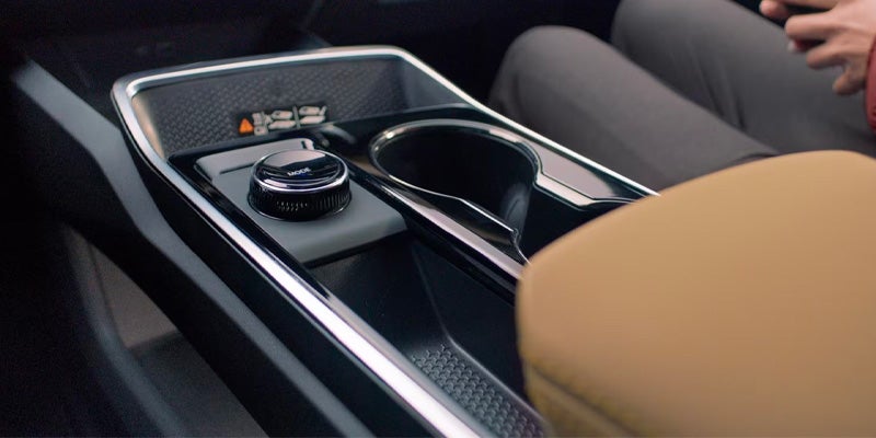 Chevrolet Equinox center console with rotary gear selector, cup holders, and modern interior storage design.