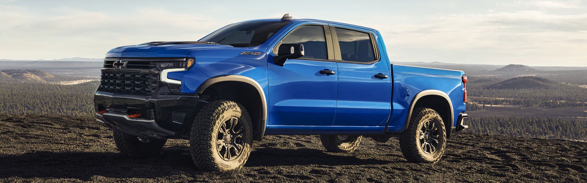 Blue Silverado on a mountain top
