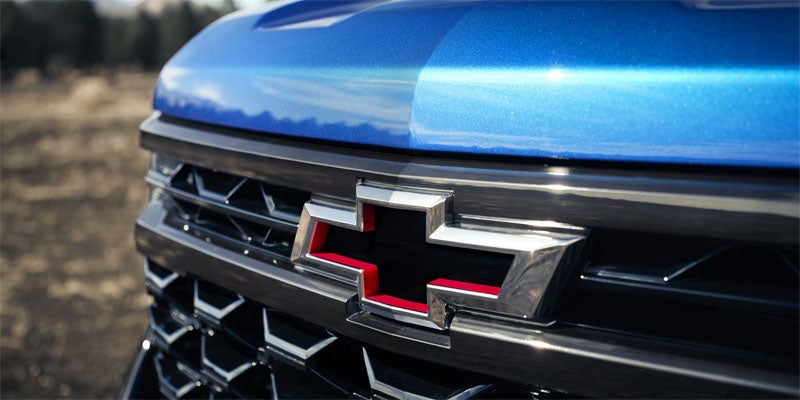 Close-up view of Chevrolet Silverado grille with illuminated bowtie emblem.