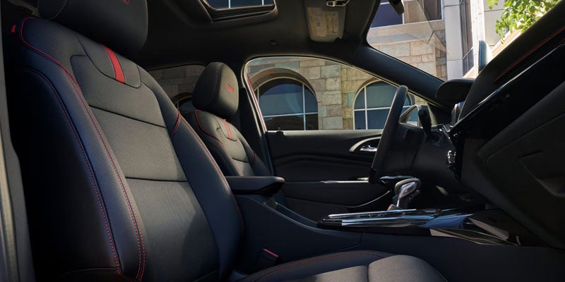 Chevrolet Equinox interior with sport-inspired seats, red stitching, and modern center console design.